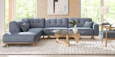 a living room with a blue couch and coffee table