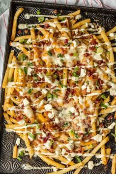 a tray filled with cheesy fries covered in cheese