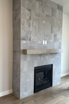 a fireplace in a living room next to a wall with a fire place on it