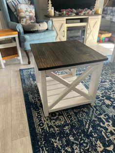 a living room with a blue chair and white table