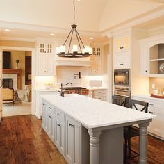 a large kitchen with an island in the middle