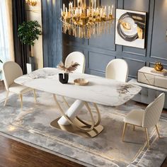 a dining room table with white chairs and a chandelier hanging from the ceiling