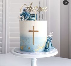 a blue and white cake with a cross on top