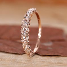 a diamond ring sitting on top of a wooden table