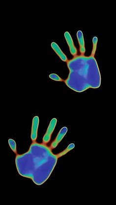 two blue and green hand prints on a black background