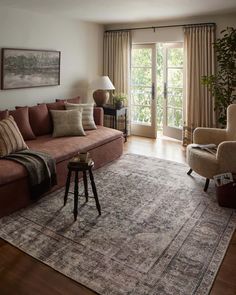 a living room filled with furniture and a large rug