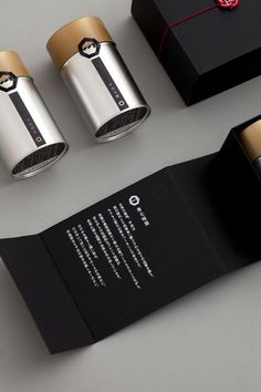 the packaging is designed to look like an open book with gold trimmings and black paper