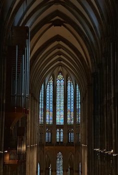 the interior of a cathedral with stained glass windows