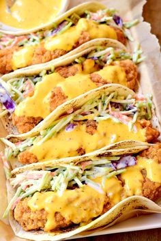 chicken tacos with cole slaw and mustard on top