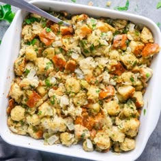 a casserole dish filled with stuffing and vegetables