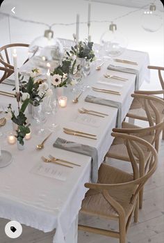 the table is set with candles and place settings for two people to sit down at