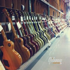 guitars are lined up on display in a store