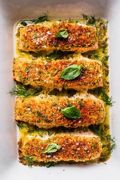 baked fish with herbs and seasoning in a white casserole dish