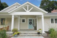 a white house with a blue front door