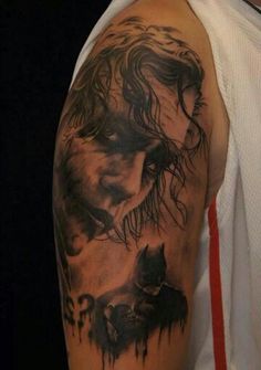 a man with a wolf tattoo on his arm and shoulder is shown in black ink