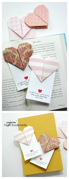 folded paper hearts are on top of an open book with the pages cut out to look like envelopes