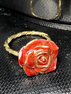 Gold tone twisted band.  A minimalist style ring with a strong statement. Red Rose enameled petals with a most darling encrusted red stone ring. Size 6.5. A fun and stylish flower that will delight even the most discerning admirer. This ring would be perfect if you love flowers, or a magical perfect gift for someone who loves roses too. As a vintage item, this is one of one. Twisted Band Ring, Red Tourmaline, Red Stone Ring, Chocker Necklace, Twisted Band, Rose Rouge, Red Band, Love Rose, Red Stone