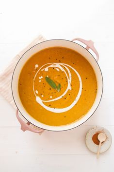 an overhead view of a bowl of carrot soup