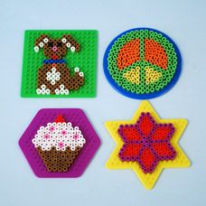 four pieces of bead art on a white surface