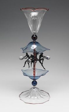 a glass vase with three people on it