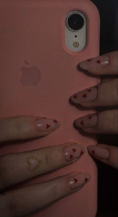 a woman's hand holding an iphone case with nails on it