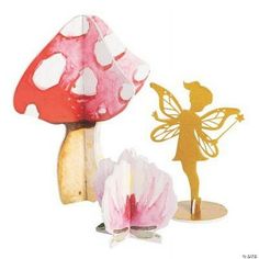 a paper cut out of a fairy standing next to a mushroom with a flower in front of it