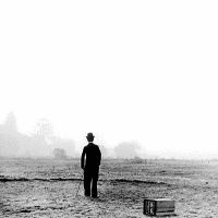 a man standing on top of a dry grass field