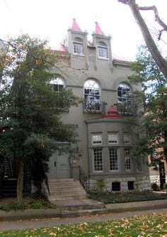 a large gray building with many windows and trees