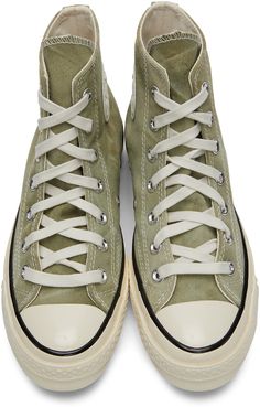 High-top organic canvas sneakers in tones of green. Fading throughout. Round rubber cap toe in off-white. Lace-up closure in white. Eyelet vents and leather logo patch in white and black at inner side. Tonal webbing trim at heel. Rubberized stripe in black at welt. Rubber midsole in off-white featuring stripe in black and logo patch in black at heel. Treaded rubber outsole in brown featuring speckled detailing in off-white. Silver-tone hardware. Supplier color: Light field surplus/Egret Converse High Tops Platform Lyst, Converse White High Tops Chuck Taylors, Leather High Top Shoe, Cool Converse Wornout, Shoe High Tops, White Platform Converse Tops, Skate Board Converse, Converse 1 Star Green, Converse Cream High Tops