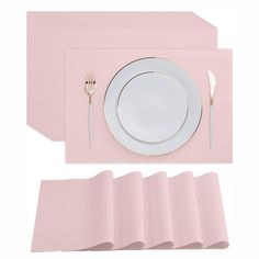 a place setting with pink napkins and plates