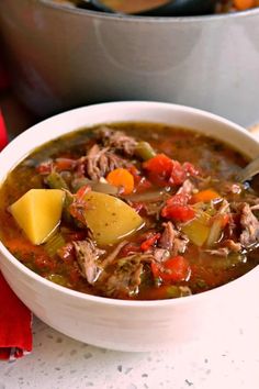 a bowl of soup with meat and vegetables