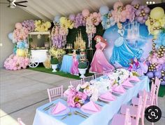 a princess themed birthday party with balloons and tableware set up in front of the wall