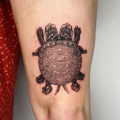 a small turtle tattoo on the leg