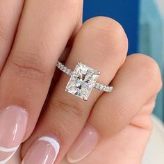 a woman's hand with a ring on it and a diamond in the middle