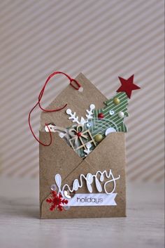 a small christmas card with the words happy holidays on it and a paper snowflake