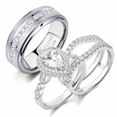 two white gold wedding rings with diamonds on each band and an oval shaped diamond in the middle