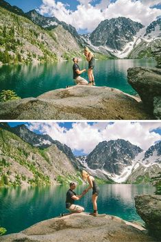 two people sitting on top of a large rock next to a body of water with mountains in the background