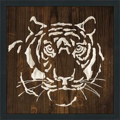 a tiger's head painted on wood with the word tigers written in white ink