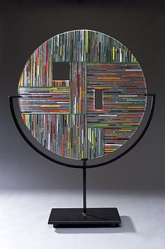 a metal sculpture with various colored strips on it