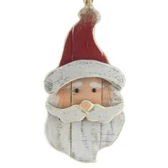 a wooden santa claus ornament hanging on a white wall with a red hat