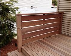 a wooden bench sitting on top of a wooden deck