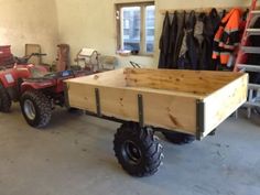 an atv pulling a trailer in a garage