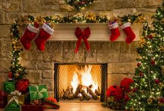 a fireplace decorated for christmas with stockings and presents