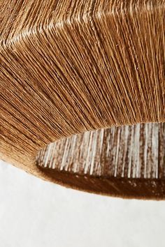 a close up view of the top of a wooden chair with woven fabric on it