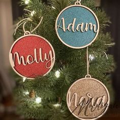 three ornaments hanging from a christmas tree with the word, name and initials on them