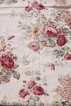 an image of a flowered fabric with red and pink flowers on white background, close up