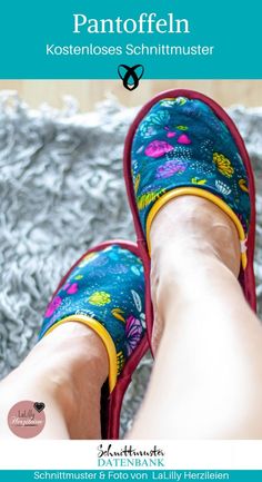 the legs and feet of a person wearing slippers with flowers on them, sitting on a bed