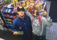 two people taking a selfie in front of a store