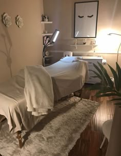 a room with a bed, desk and lamp on it's side in front of a mirror