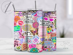 two insulated tumbles with colorful stickers on them